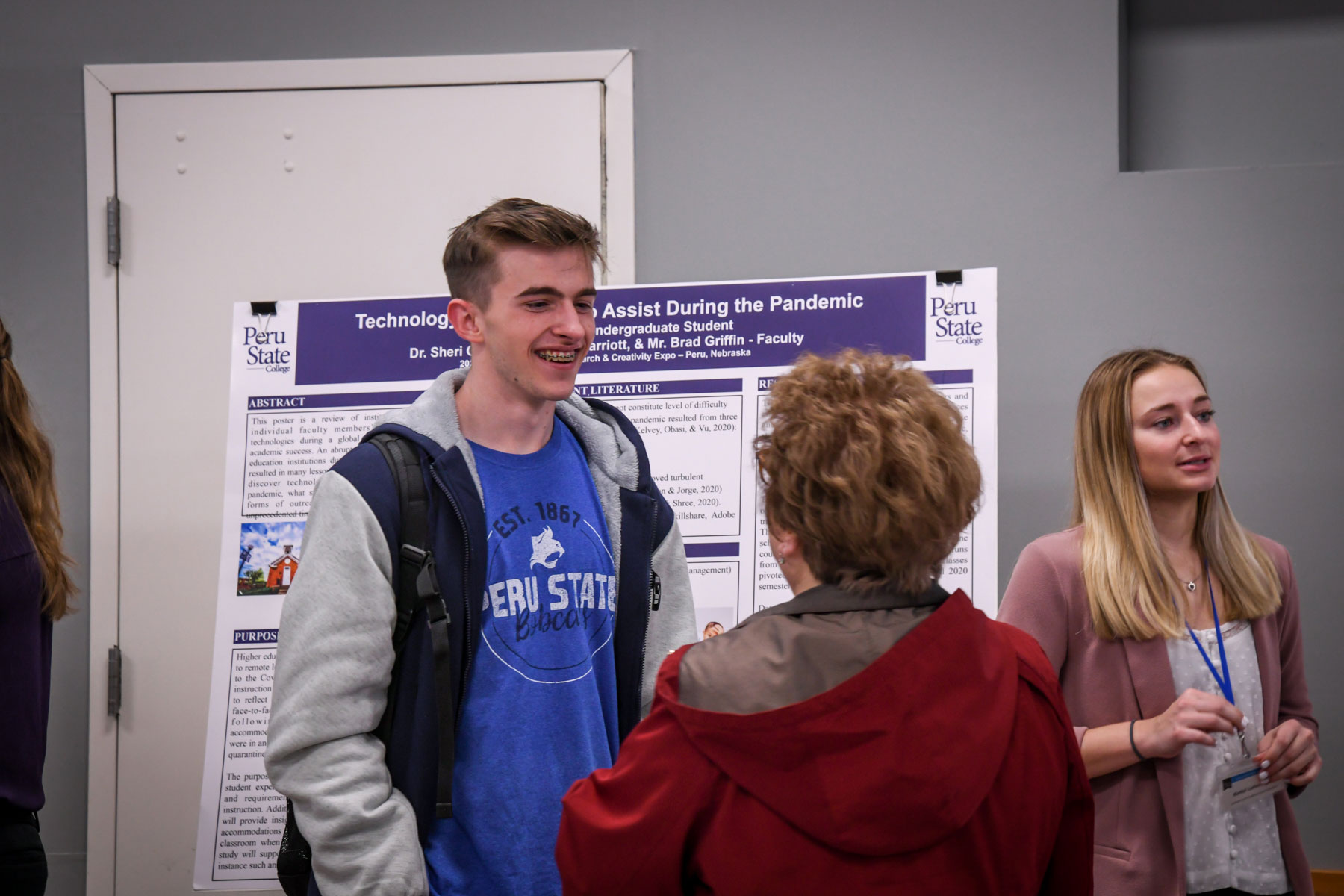 male student presenting a poster